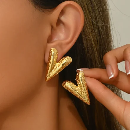 Woman wearing textured V-shape gold earrings – stainless steel waterproof jewellery India