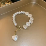 Handmade white beaded bracelet with heart-shaped pearls and gold charm for women