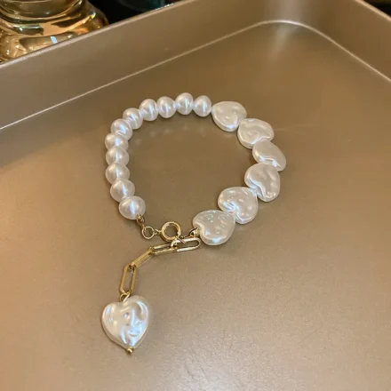 Handmade white beaded bracelet with heart-shaped pearls and gold charm for women