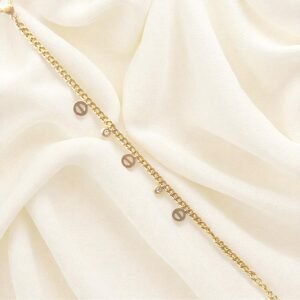 Elegant gold-plated charm bracelet with delicate round charms and cubic stones on wrist