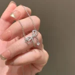 Bowknot Zircon Pendent Necklace. Elegant bowknot zircon pendant necklace in silver finish with sparkling zircon stones, dainty clavicle chain jewelry for women