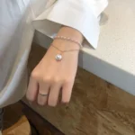 Woman wearing stylish pearl bracelet – double layer imitation pearls gold plated bracelet for women India