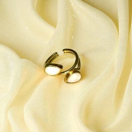 Gold-plated open ring with dual white stones on pink silk background – elegant adjustable jewelry piece for women.Gold-Plated Open Ring with White Stones