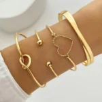 Cocktail Bracelet Set of 4 featuring gold plated minimal bangles with heart, knot, and open-end designs for women