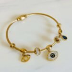 Gold Evil Eye Magnetic Bangle Bracelet with sparkling charms and blue evil eye pendant